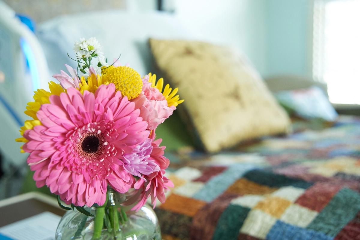 flowers beside a bed.